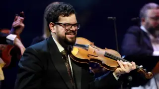 Lachende violist van The Bach Orchestra of the Netherlands tijdens een uitvoering