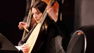 Musicus van The Bach Orchestra of the Netherlands met theorbe (historisch snaarinstrument)